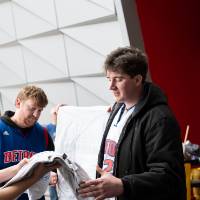 Gentleman picking up crewneck from table